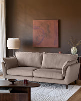 Otto 3-seater sofa in mocha fabric, displayed in a styled living room setting with neutral decor and warm lighting.