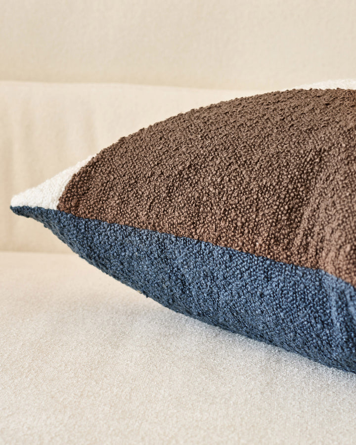 Harmony Cushion Medium in Navy - close-up of textured fabric showing color-block design with navy, cream, and brown sections.
