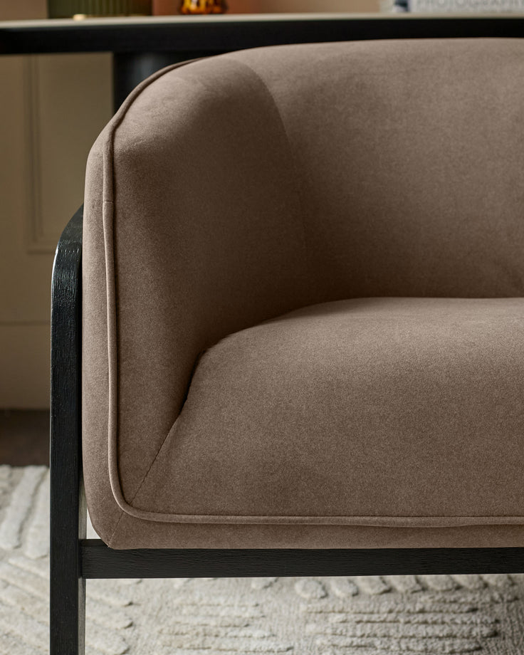 Palmer Occasional Chair in mocha fabric with curved back and black wooden frame, side view detail.