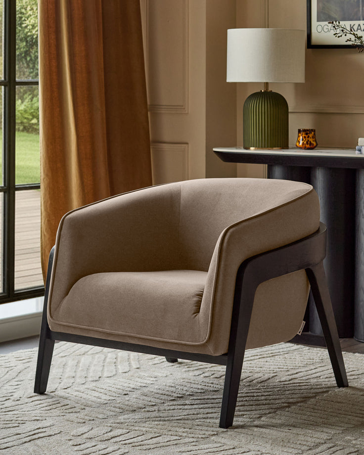 Palmer occasional chair in mocha fabric with black wooden legs, shown in a styled living room setting.