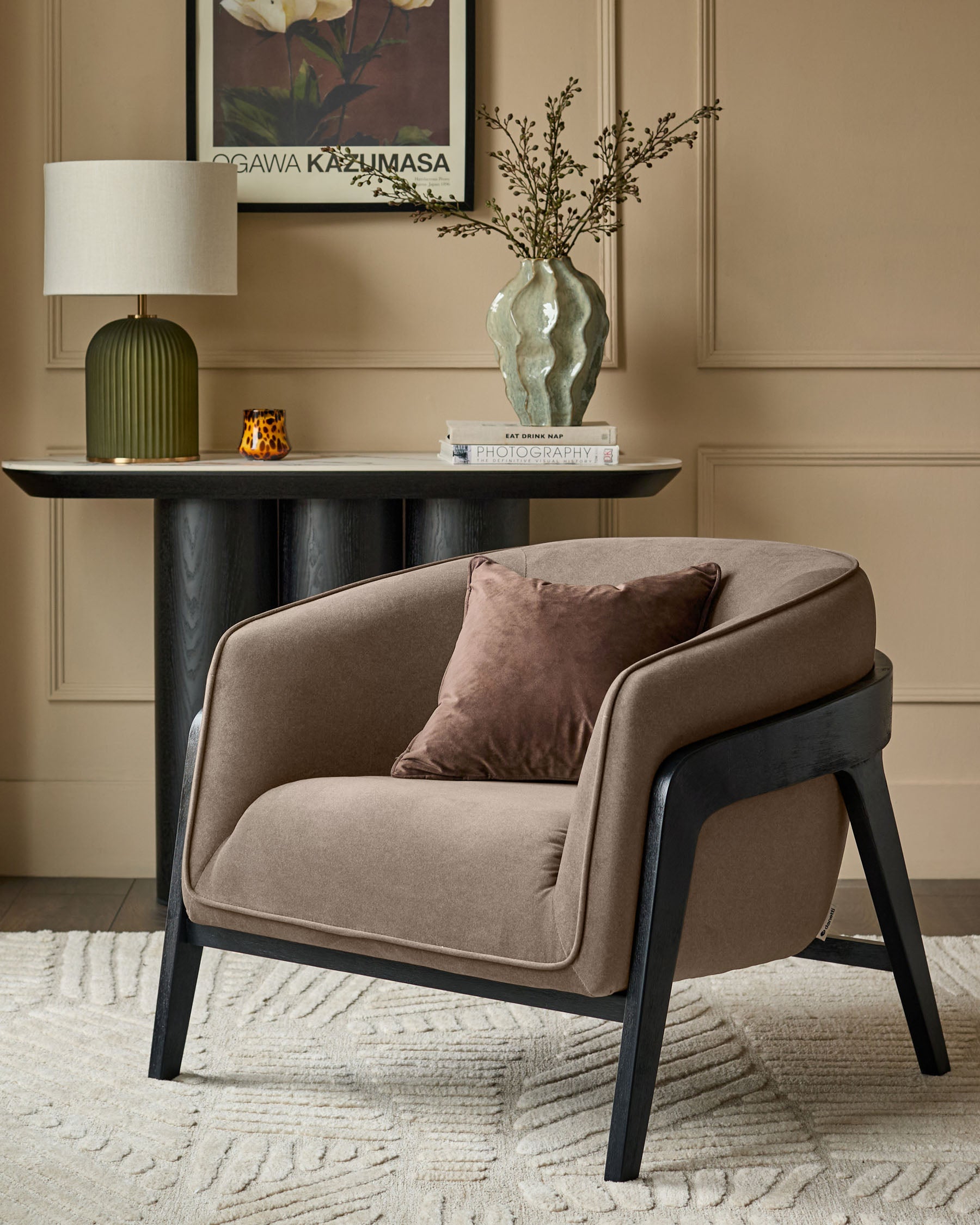 Palmer Occasional Chair in mocha fabric with black wooden legs, shown in a styled living room setting.