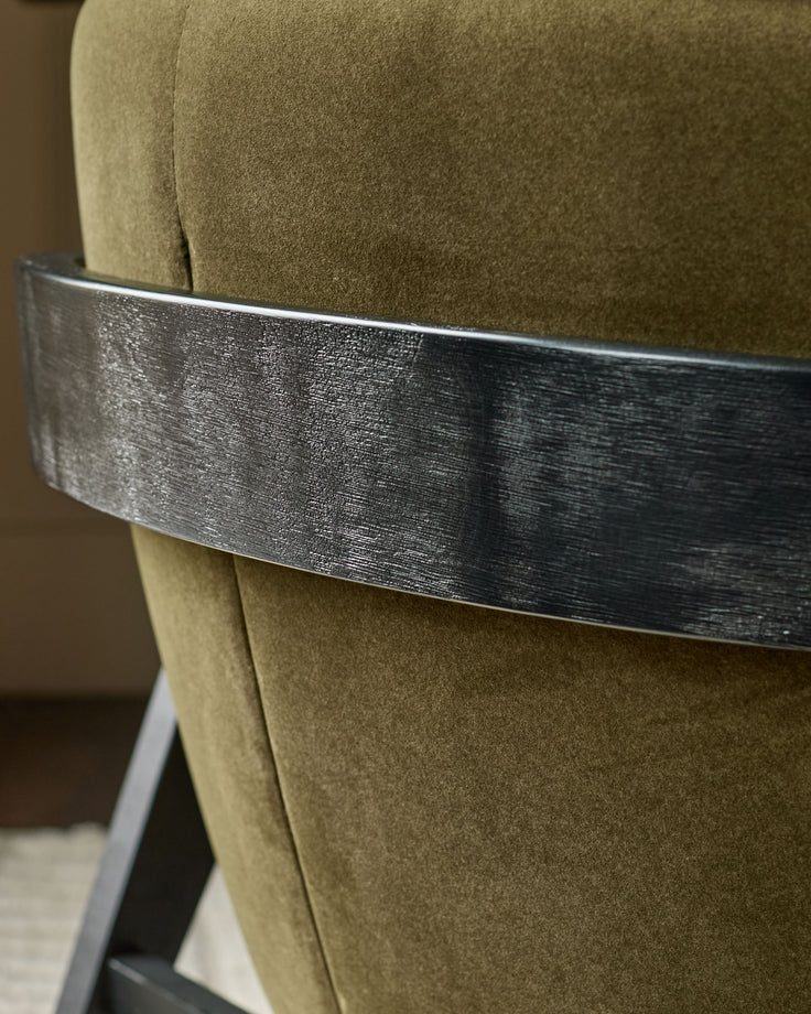 Palmer occasional chair in pistachio green fabric with brushed metal band detail, close-up side view.