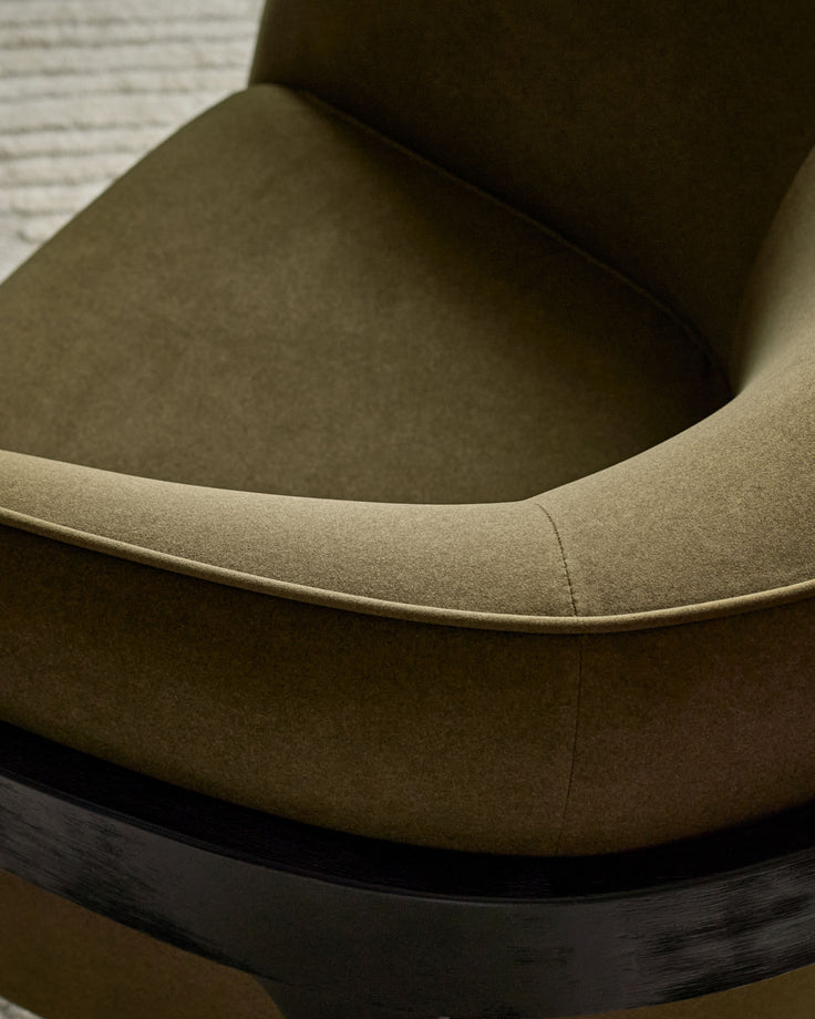 Palmer occasional chair in pistachio green fabric, showing curved armrest and seat detail with dark wooden base.