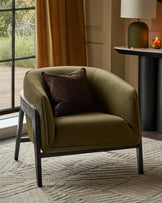 Palmer Occasional Chair in pistachio green fabric with dark wooden frame, featuring a brown accent pillow in a styled living room setting.