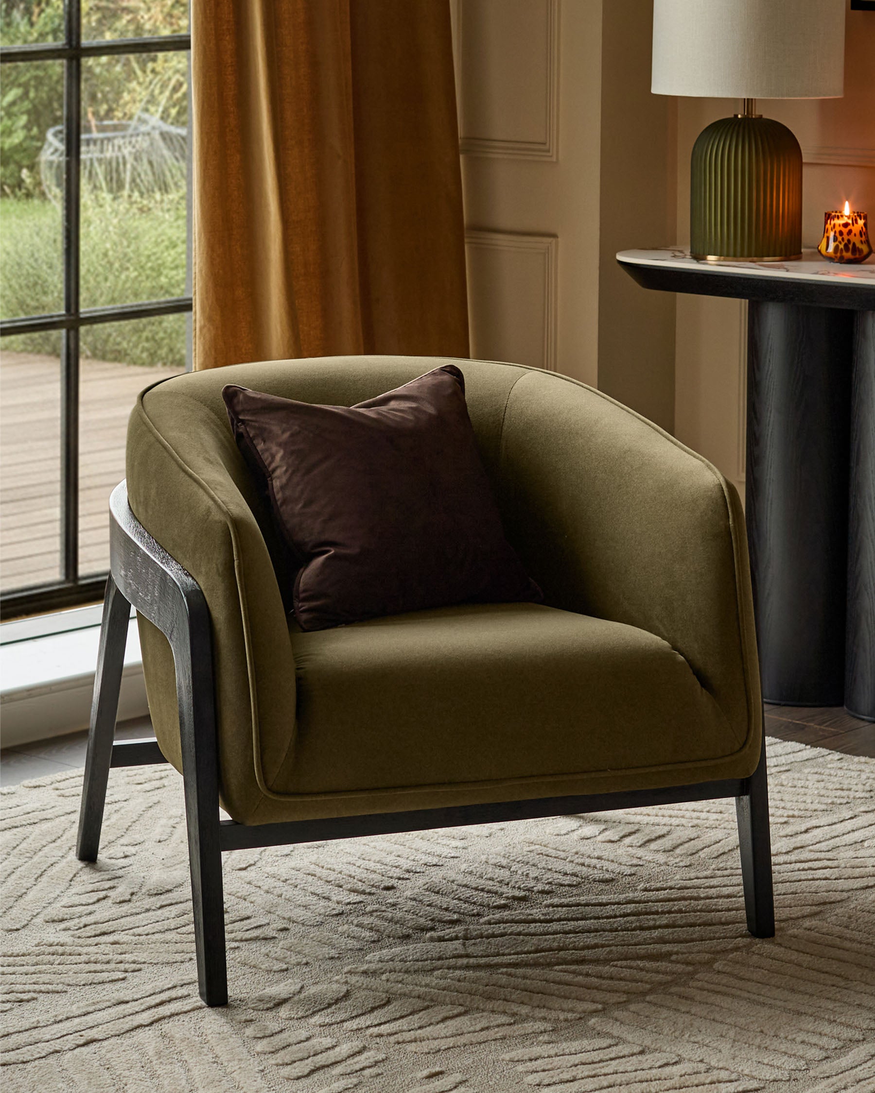 Palmer Occasional Chair in pistachio green fabric with dark wooden frame, featuring a brown accent pillow in a styled living room setting.