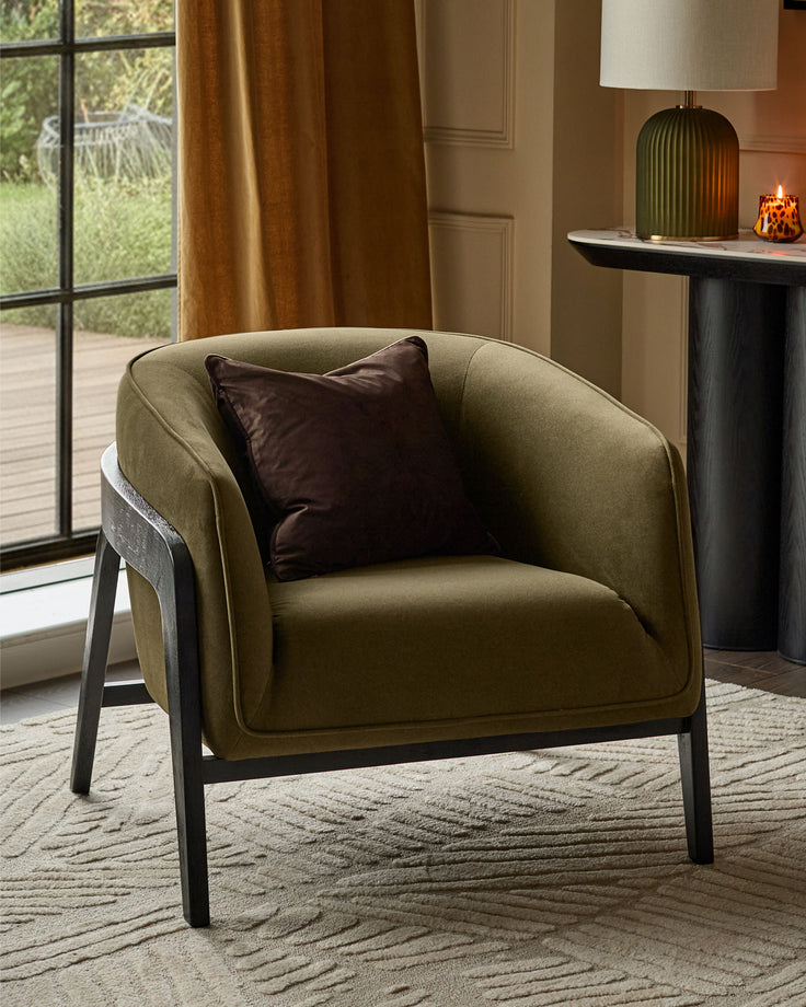 Palmer Occasional Chair in pistachio green fabric with dark wooden frame, featuring a brown accent pillow in a styled living room setting.