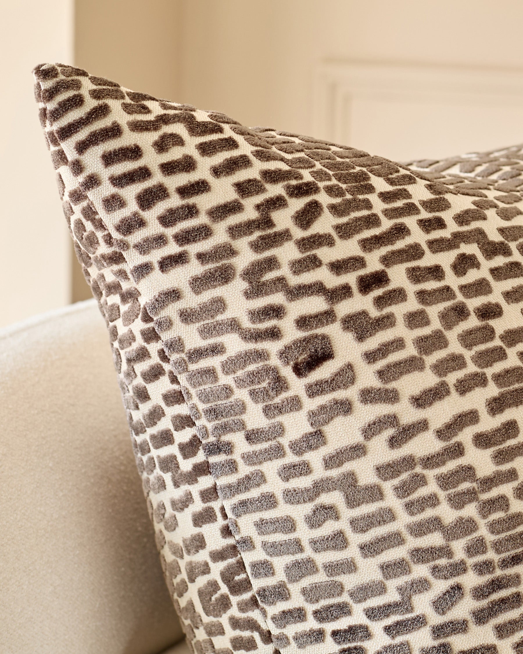Payton cushion in large size with chocolate brown and cream geometric pattern, angled view showing texture and shape.