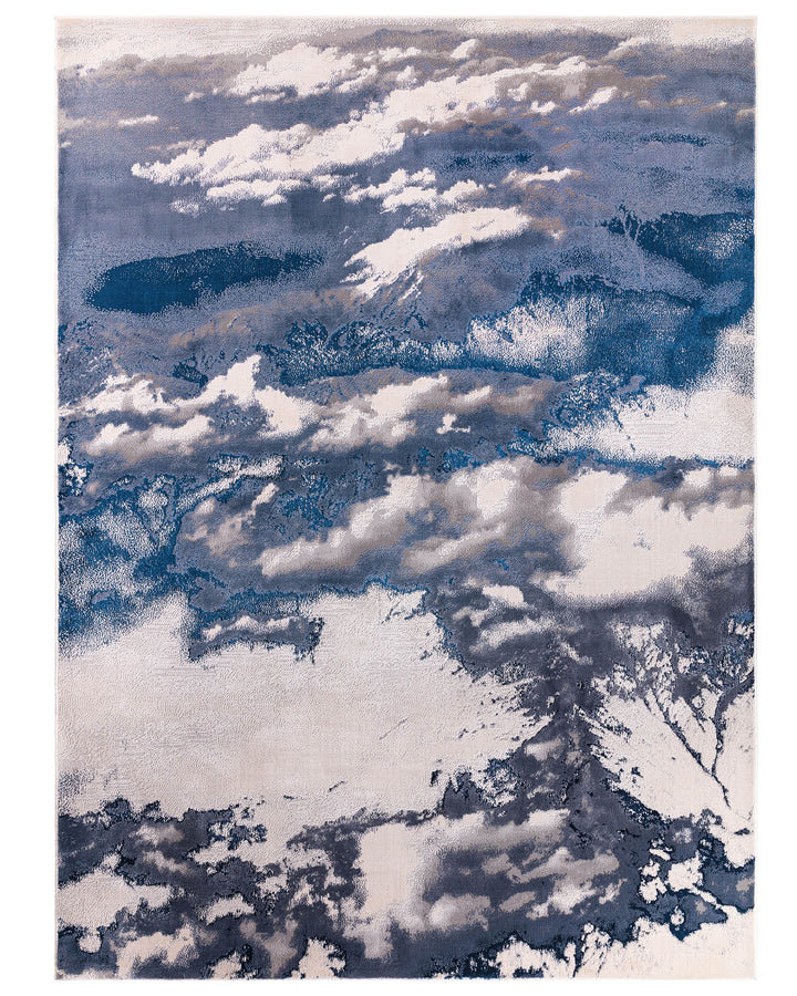 A modern rug with a cloud-like abstract design in shades of blue, grey and cream.
