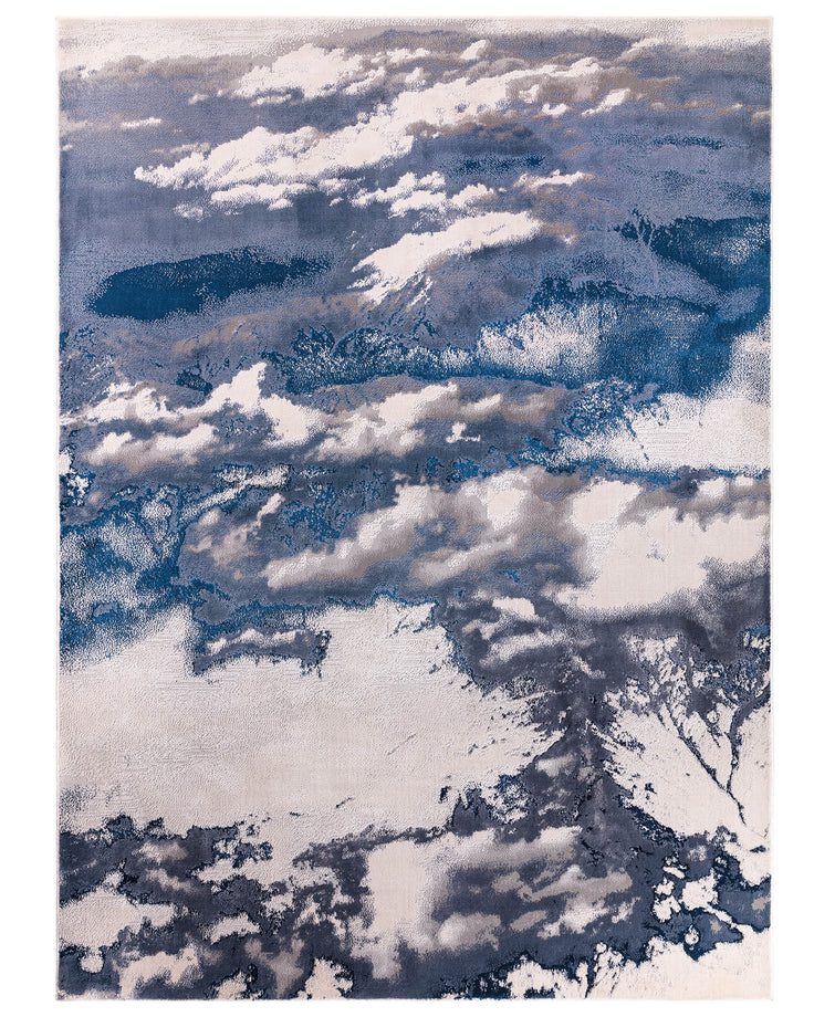 A modern rug with a cloud-like abstract design in shades of blue, grey and cream.