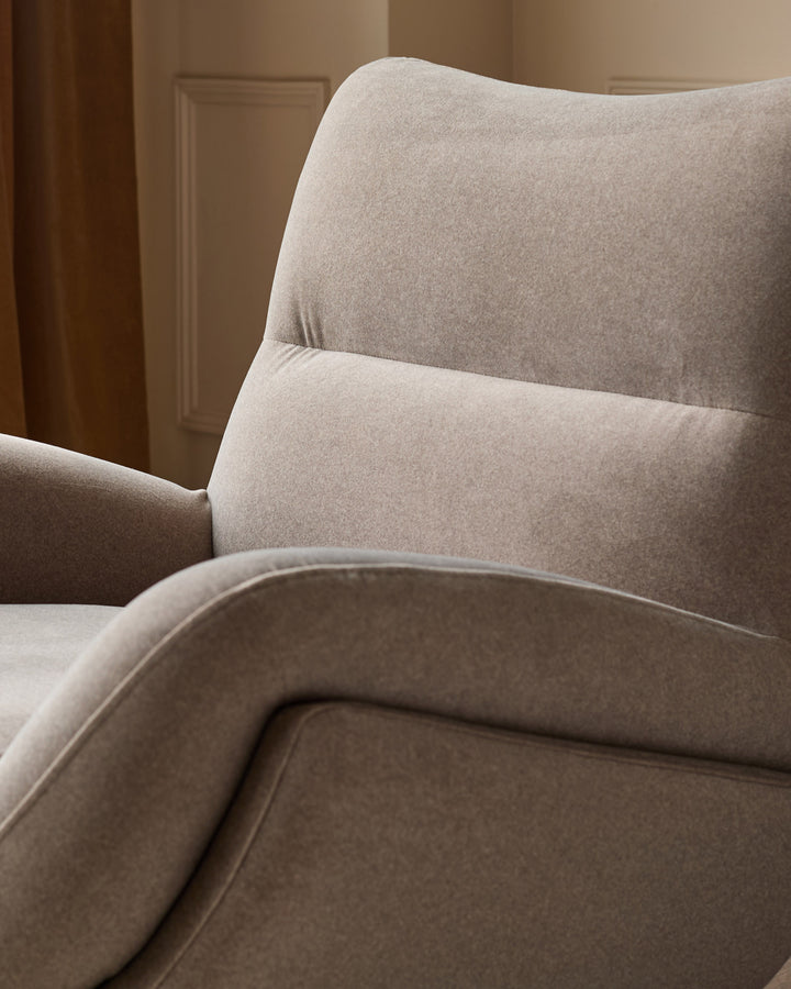 Piper accent chair in mocha fabric, showing curved backrest and armrest from side angle in warm interior setting.