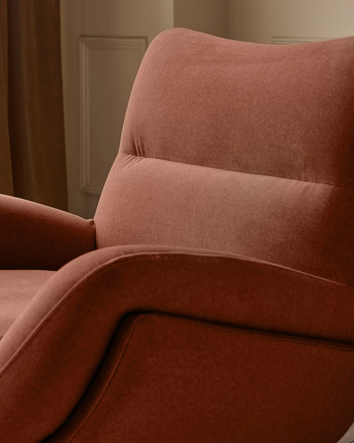 Piper accent chair in toffee red fabric, side view showing curved backrest and armrest detail.