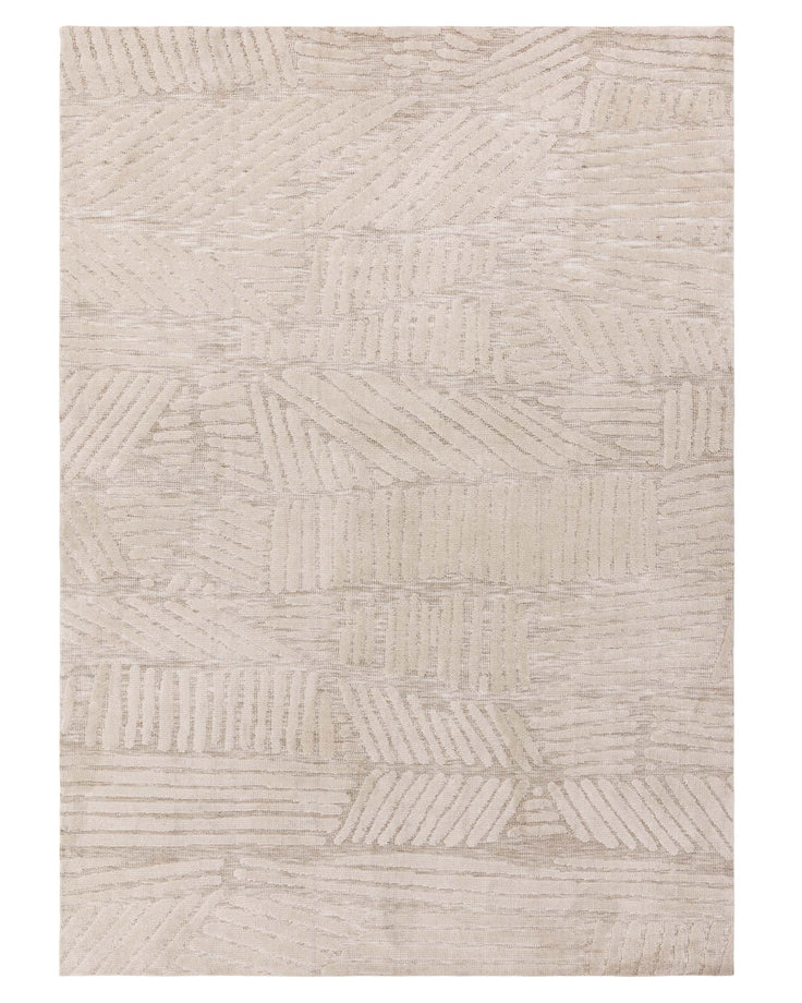 Contemporary beige area rug with a textured leaf pattern design.