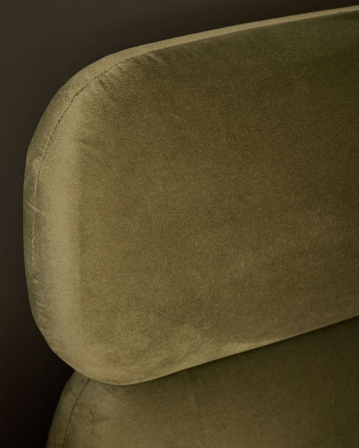Preston king-size bed in olive-green velvet, showing curved headboard detail and soft fabric texture.