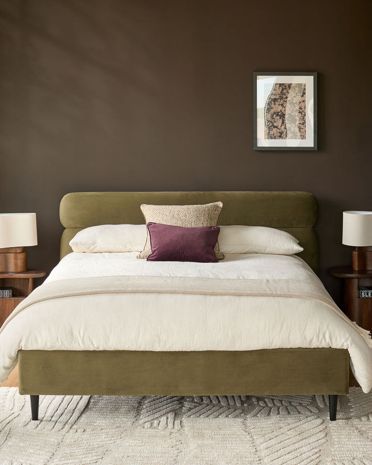 Preston King-Size Bed in olive green velvet with cream bedding, styled in a bedroom setting with side tables and wall art.