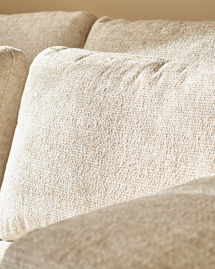 Quinn 2-seater sofa in natural fabric, close-up of textured upholstery and cushioned armrest detail.