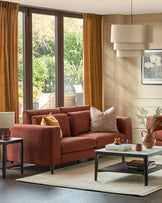 Quinn 3-seater sofa in toffee red fabric, displayed in a styled living room with decorative pillows and dark legs.