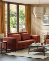 Quinn 3-seater sofa in toffee red fabric with dark legs, displayed in a bright living room setting.
