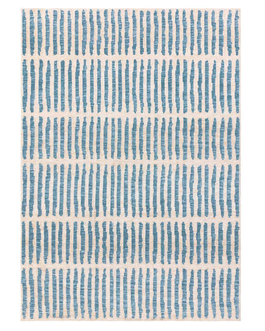 A patterned rug with blue vertical stripes on a cream background, ideal for adding texture and interest to any room.