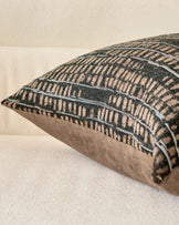 Rania Cushion Large in black, shown at an angle displaying its textured geometric pattern and neutral linen back panel.