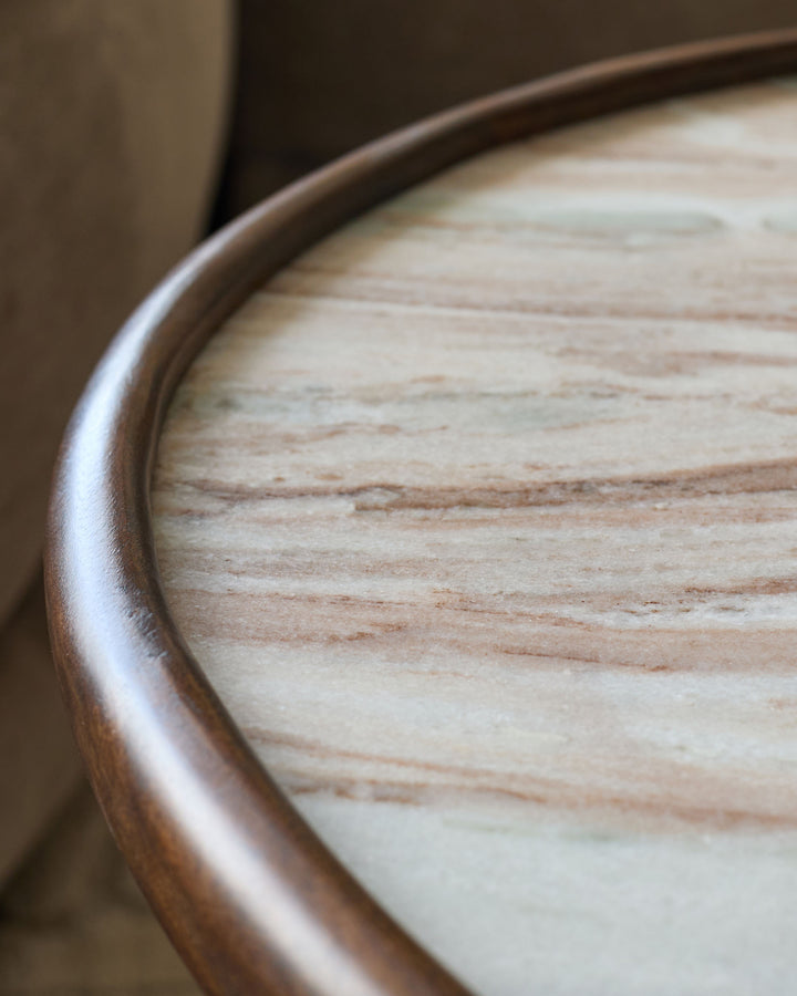 Close-up of Rayna dark wood coffee table showing polished natural wood grain and curved edge detail.