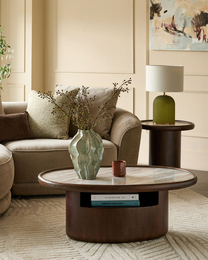 Rayna dark wood coffee table with round Toronto marble top, open shelf storage, styled in modern living room.