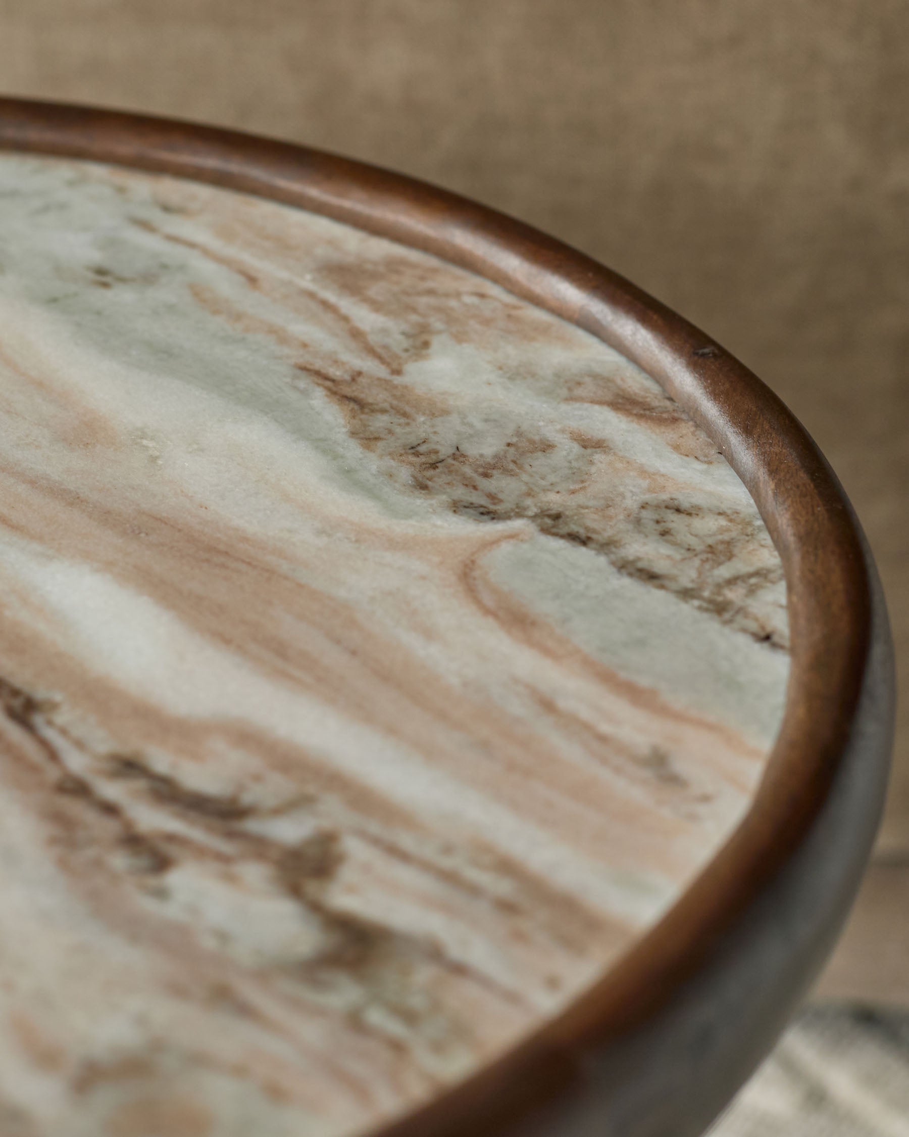 Rayna side table with dark wood frame and marble top, close-up angled view showing wood grain detail.