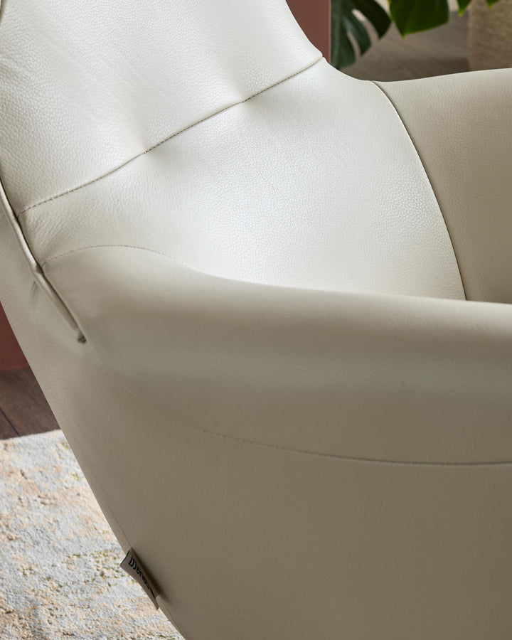 Reign Occasional Chair in natural grey leather, side angle view showing curved armrest and textured upholstery detail.