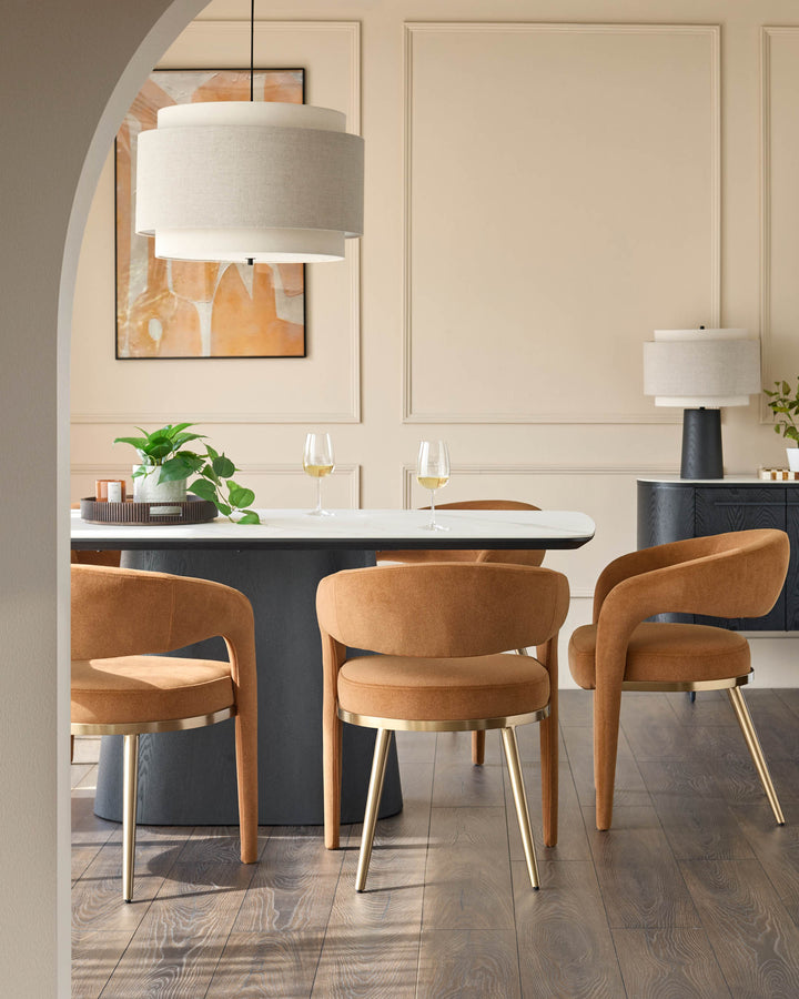 Dining room with table, tan upholstered chairs with gold legs, pendant light, and sideboard.