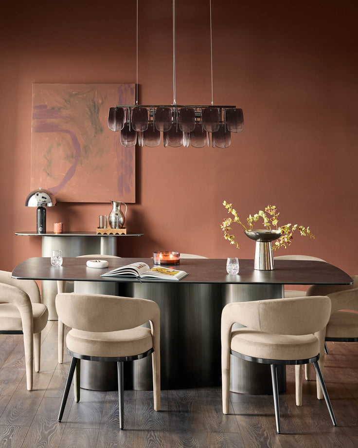 Champagne velvet dining chair with curved back and black metal legs, shown at modern table in warm terracotta room setting.
