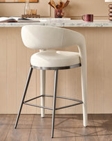 A stylish cream bar stool with a metal frame, perfect for modern kitchens and dining areas.