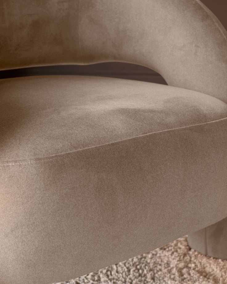 Rhett accent chair in natural fabric, close-up showing curved armrest and upholstered seat detail.