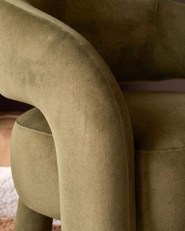 Rhett accent chair in pistachio fabric, close-up detail of curved armrest and stitching.