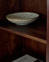 Dark mango wood sideboard with open shelf displaying a speckled ceramic bowl.