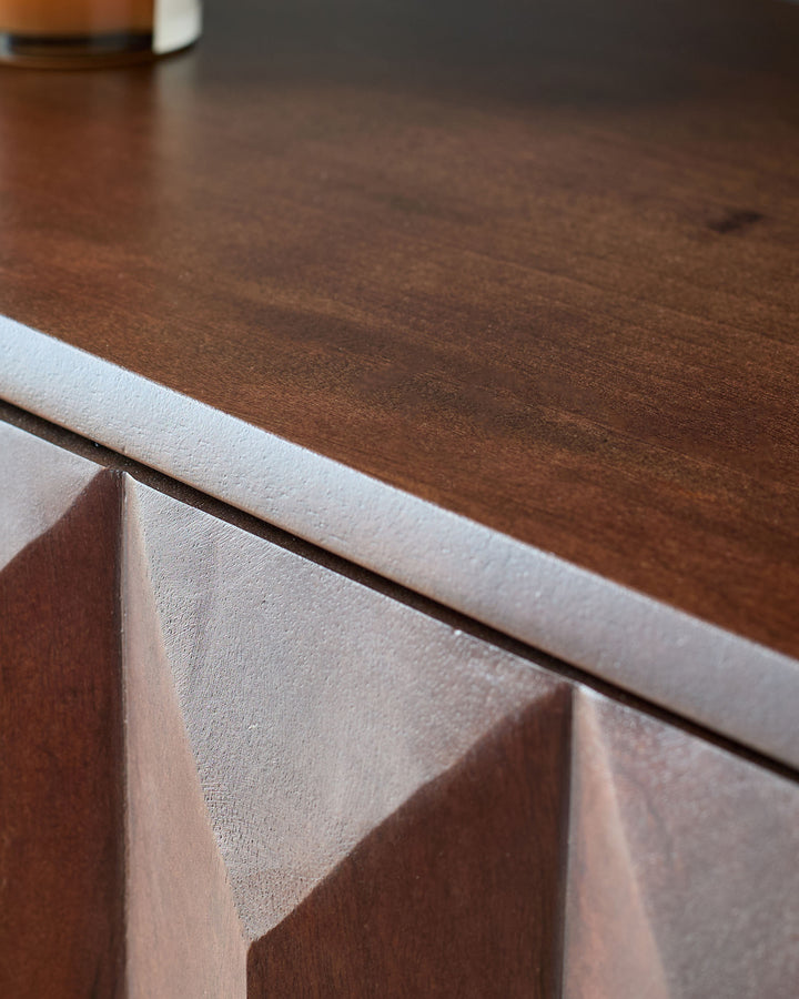 Dark mango wood sideboard with white trim and geometric handle detail, close-up angle