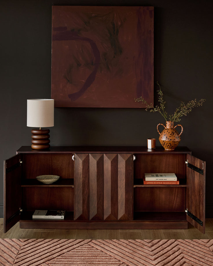 Dark mango wood sideboard with open cabinet doors, vertical slat detailing, and interior shelving displayed in a styled room setting.