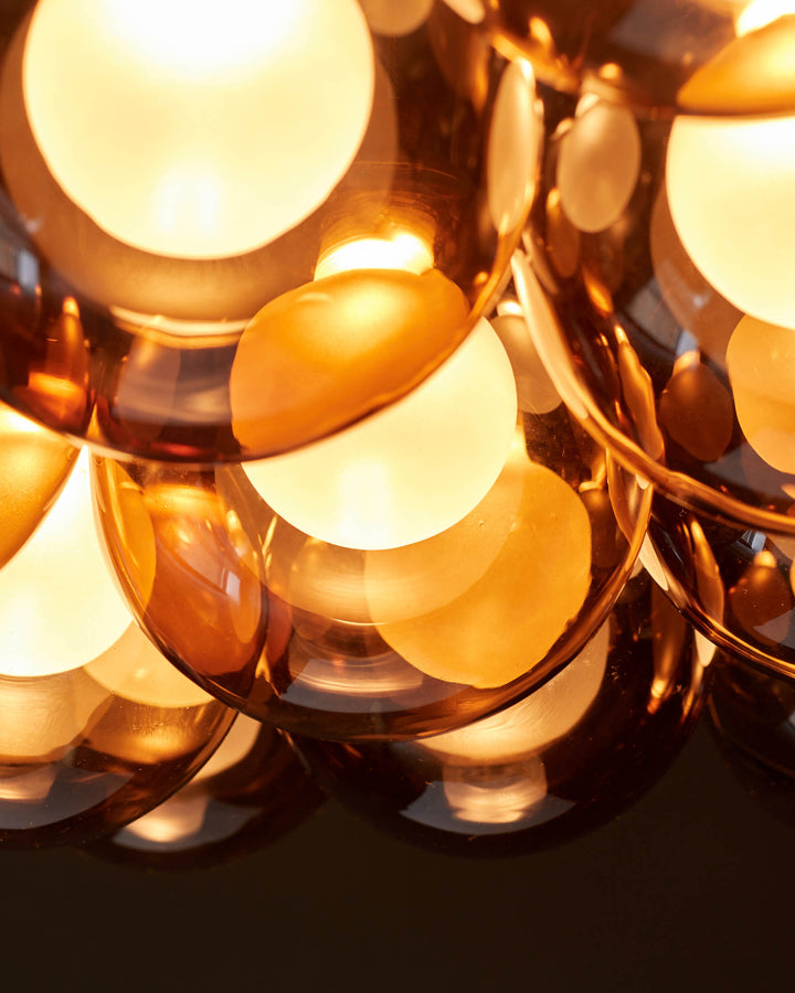 Cluster of globe lights. Warm, inviting modern design, perfect for adding a touch of glamour to any living space.