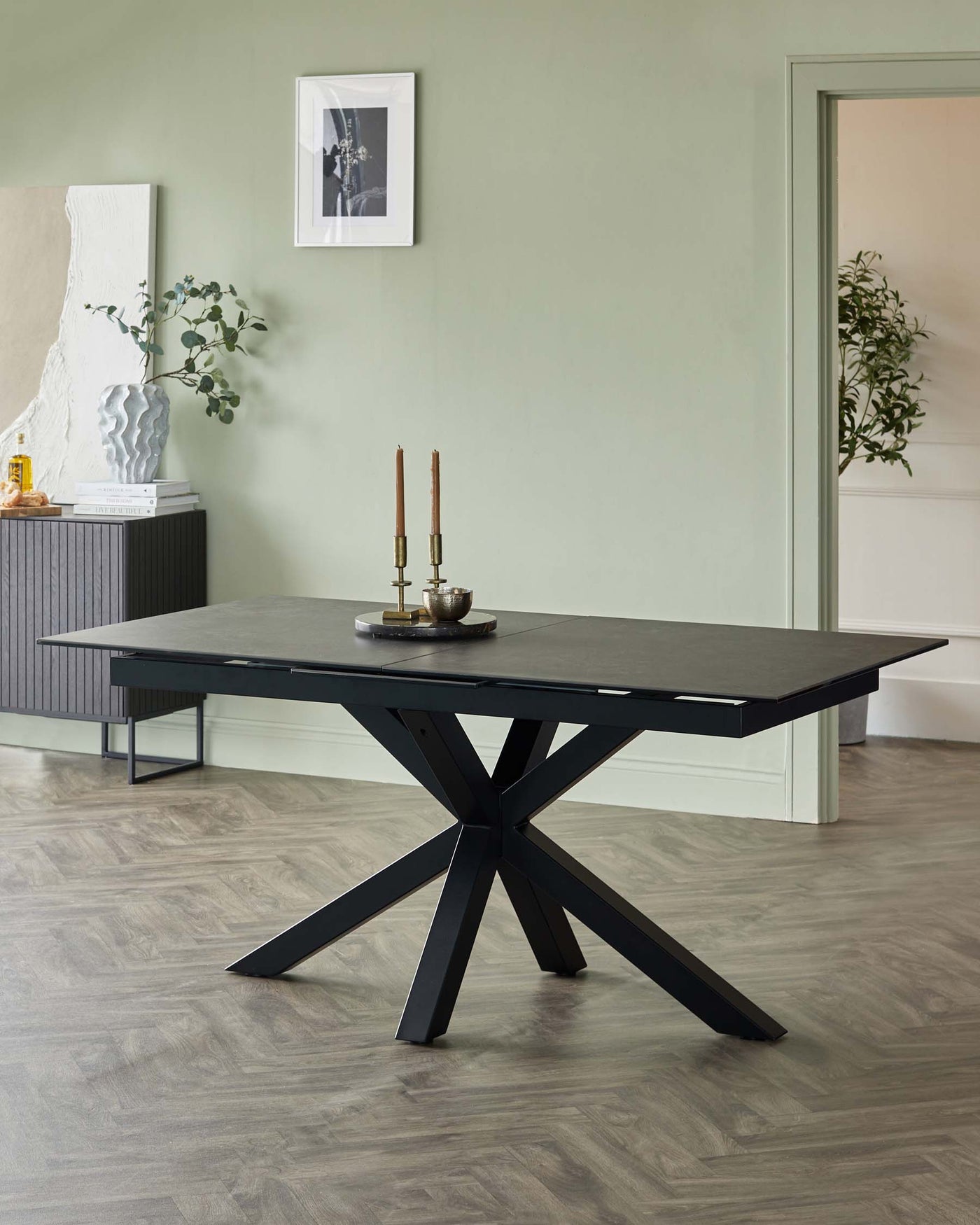 Modern rectangular dining table with a dark, textured tabletop and a bold, black crisscrossed leg design.