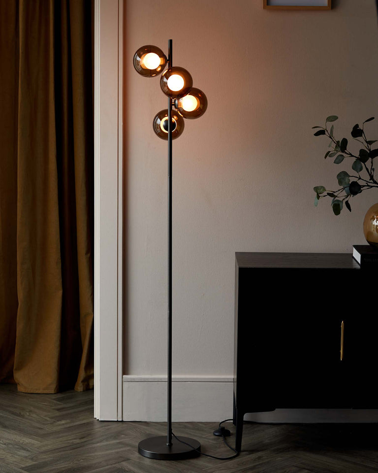A contemporary floor lamp with a sleek black finish and four spherical shades, positioned next to a modern dark wooden sideboard with brass accent handles.