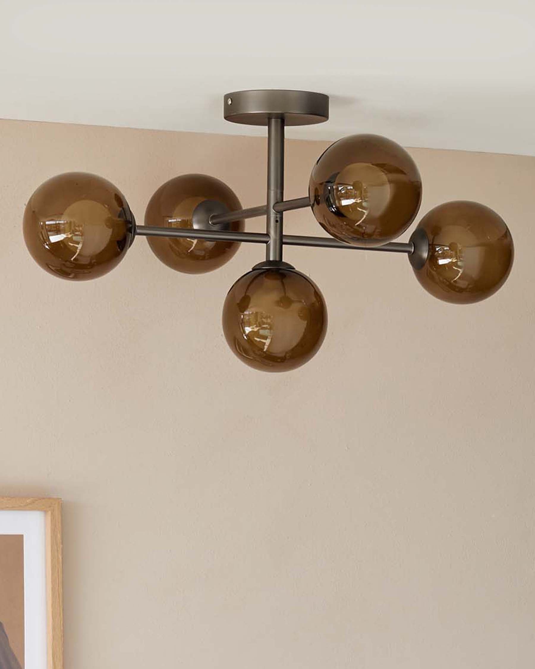Modern ceiling light fixture with six brown glass globes on a sleek metal frame, adding a stylish touch to any room.