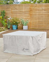 A large outdoor furniture cover in white, protecting rectangular furniture from the elements, with the "danetti garden" logo.