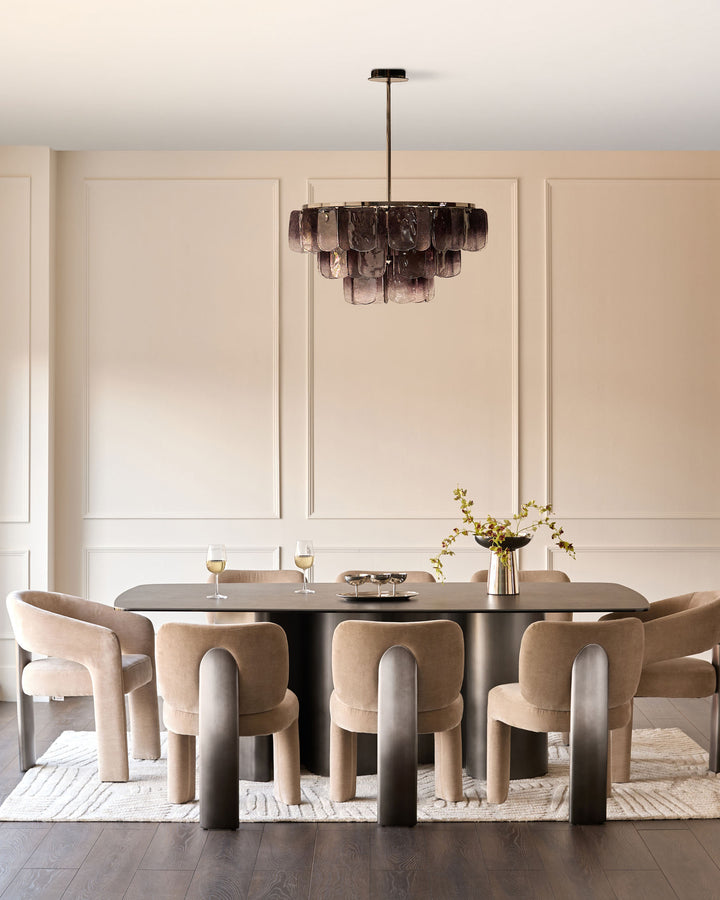 Rosalie dining chair in champagne fabric, curved barrel-back design, shown at modern dining table.