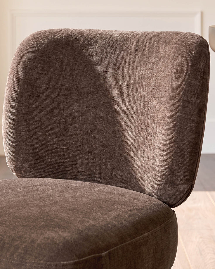 Rosalie dining chair in mocha fabric, showing curved backrest and seat from side angle.