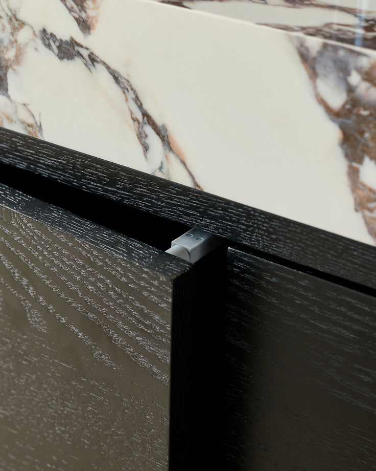 Russo sideboard in black wood finish with marble top, showing close-up detail of minimalist metal handle.