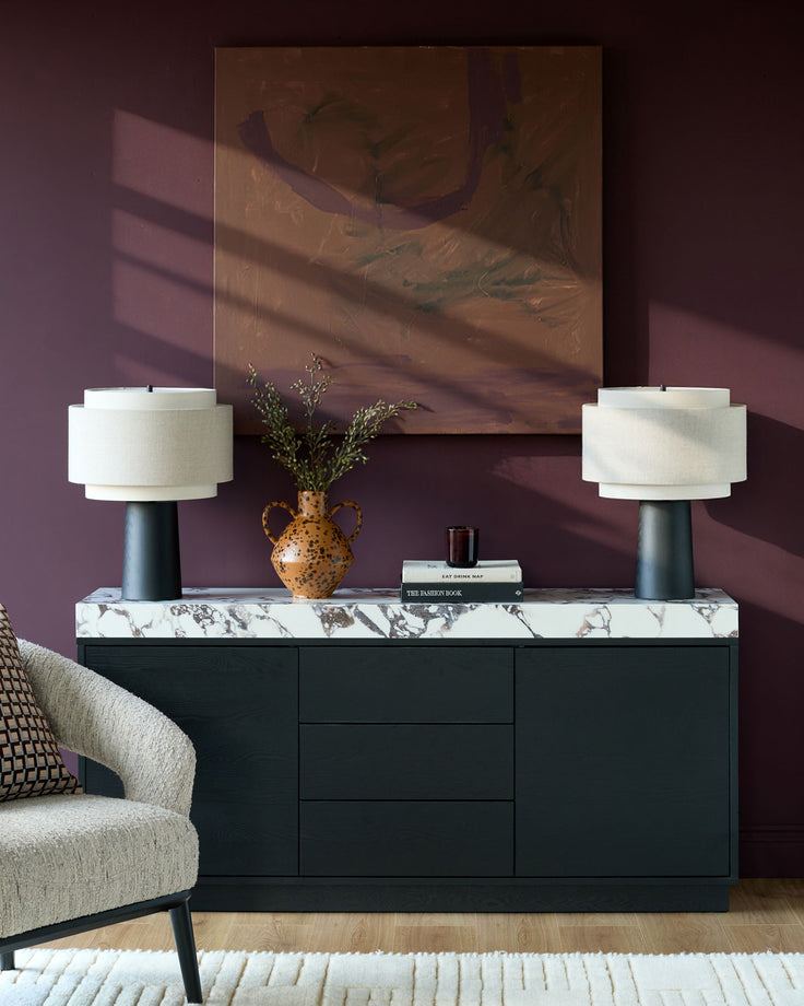 Russo sideboard in black with white Calacatta marble top, styled with lamps and décor in modern living room.