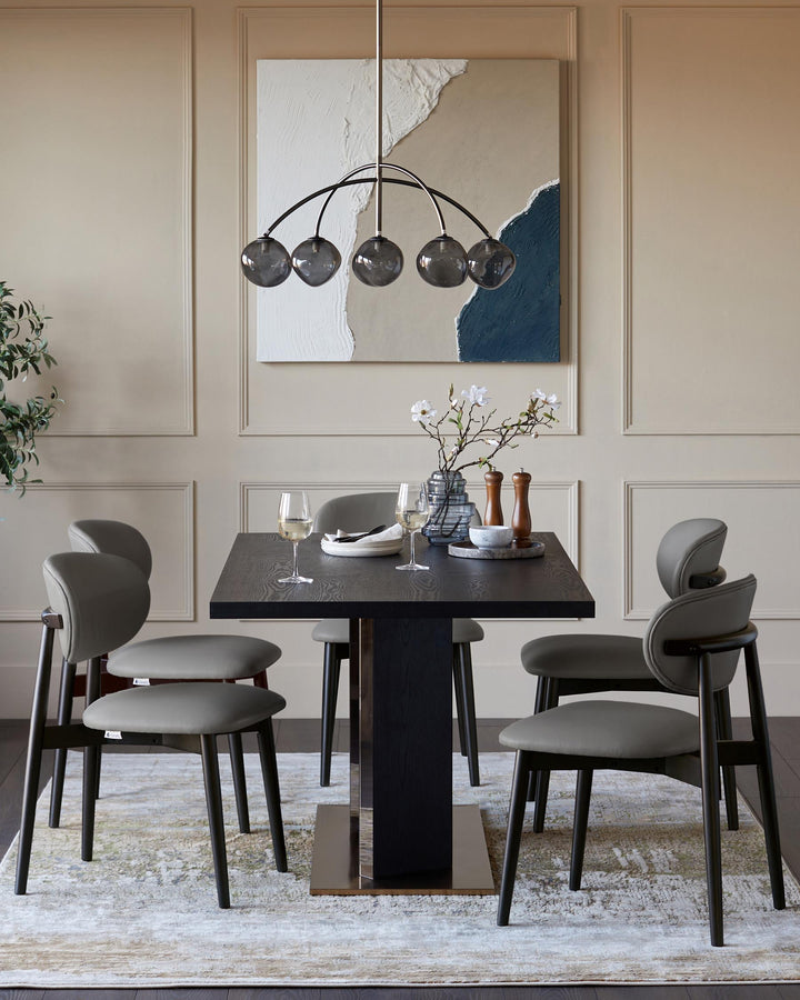 A modern dining set with a dark wood table, stylish grey chairs, and statement lighting for an elegant dining space.