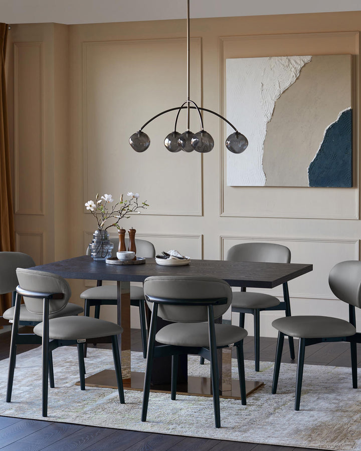 A dining table with six chairs and a globe pendant light, with neutral wall art.