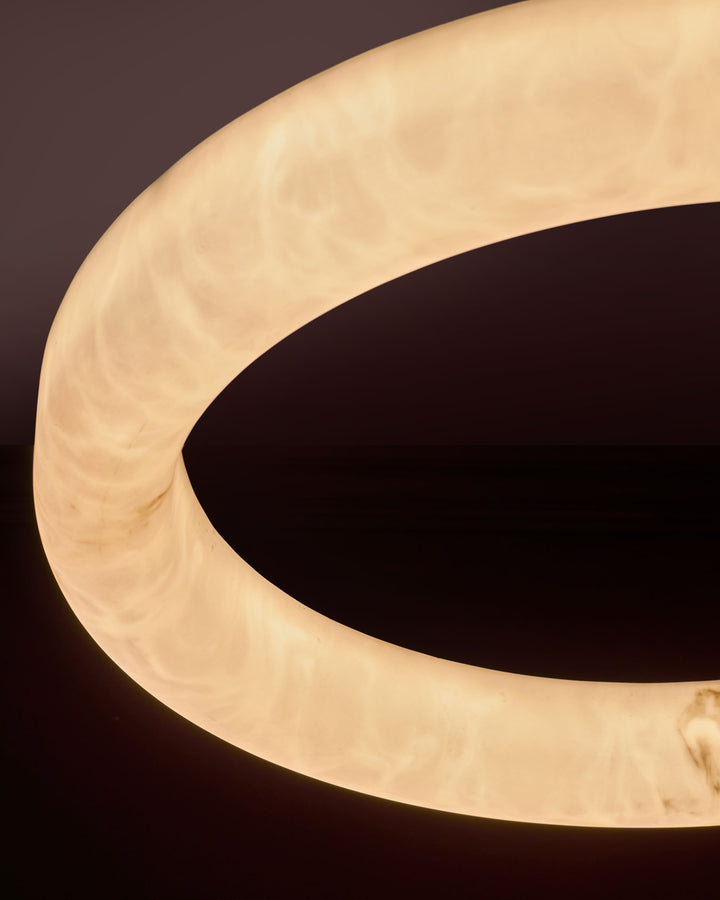 Sadie Large Pendant Light in alabaster effect with warm cream finish, showing curved sculptural shape against dark background.