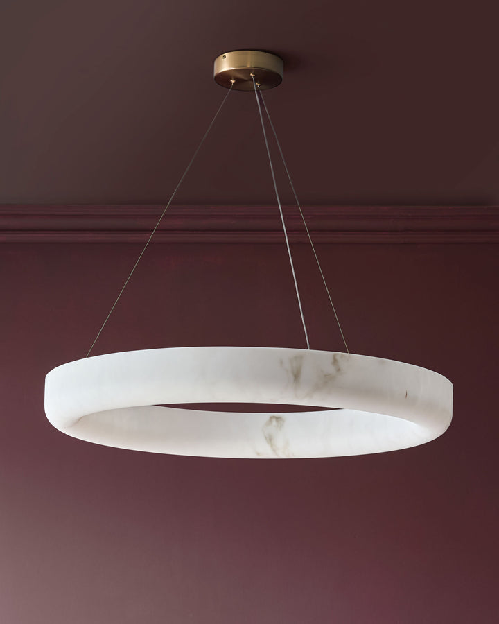 Sadie large pendant light in alabaster finish, circular ring design with brass ceiling fixture and cable suspension.