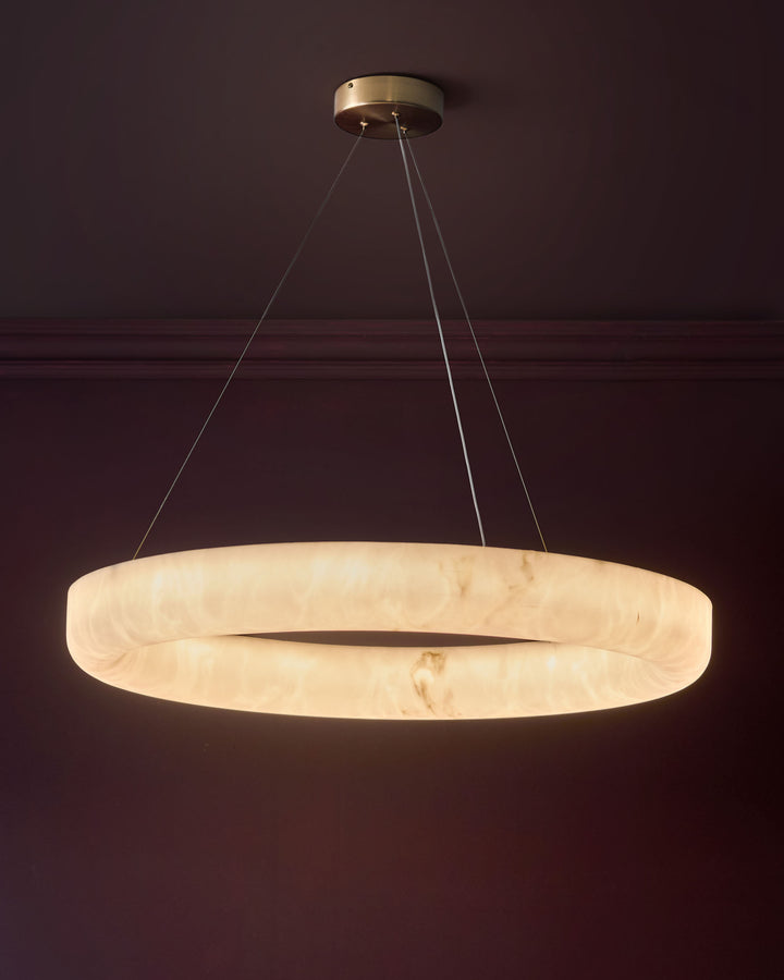 Sadie large pendant light in alabaster effect natural, circular disc shape with brass hardware and suspension cables.