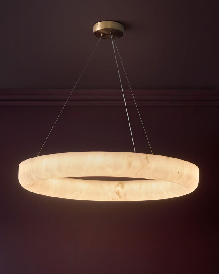 Sadie large pendant light in alabaster effect natural, circular disc shape with brass hardware and suspension cables.